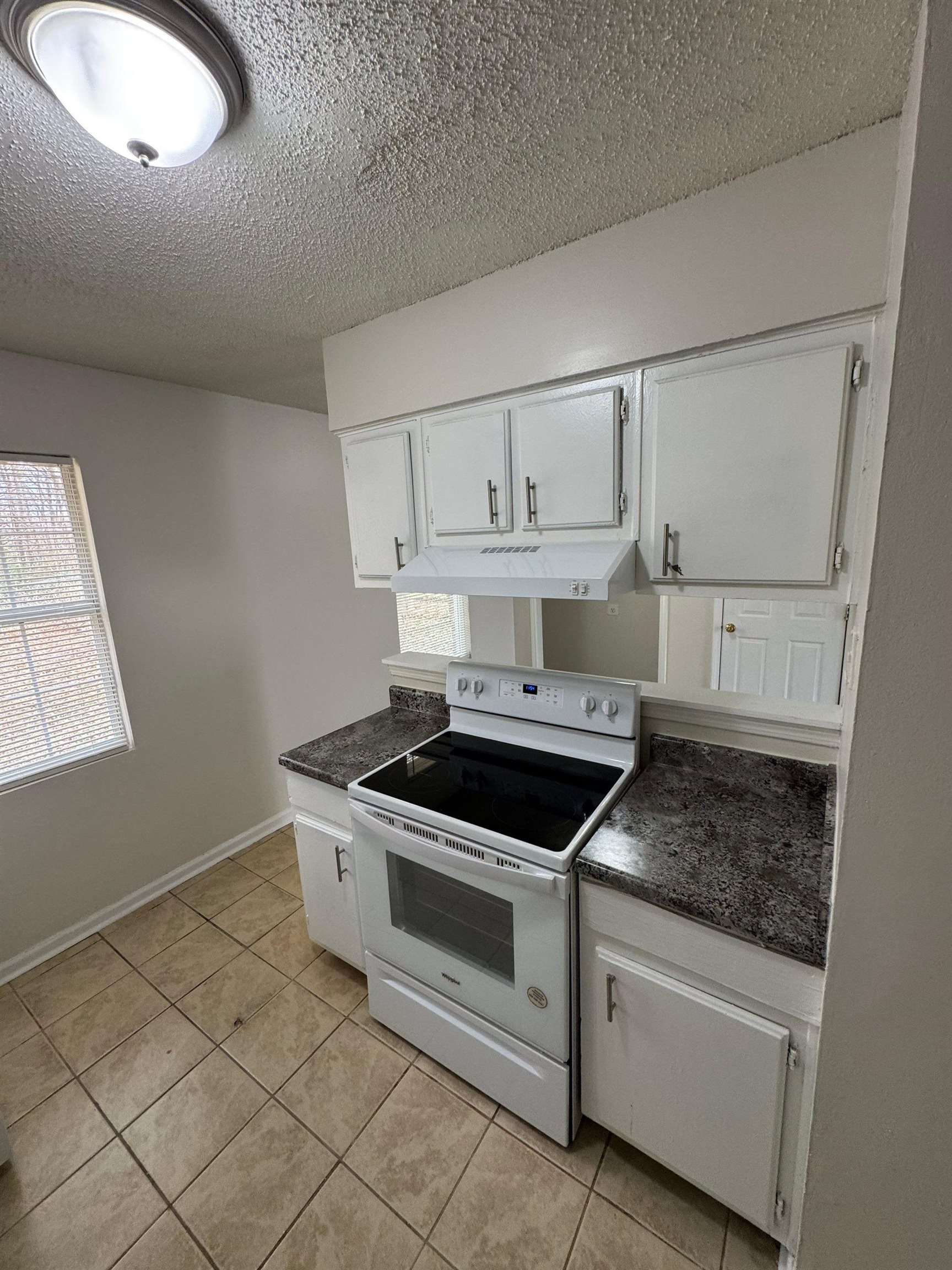 4528 Sugar Creek Road Memphis, TN 38118 - Photo 12 of 19 a kitchen with granite countertop a stove and a sink