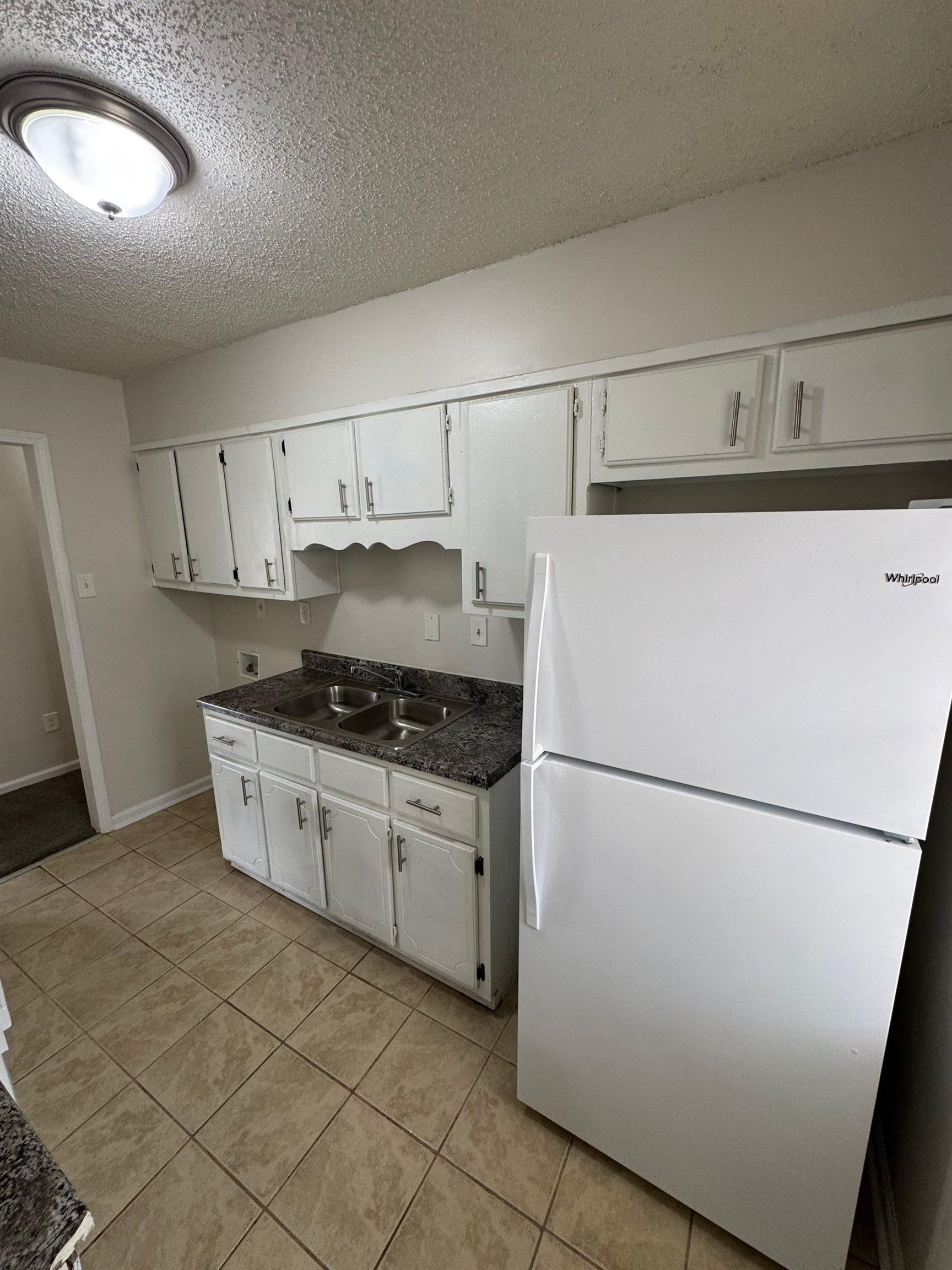 4528 Sugar Creek Road Memphis, TN 38118 - Photo 13 of 19 a kitchen with a refrigerator sink stove and cabinets