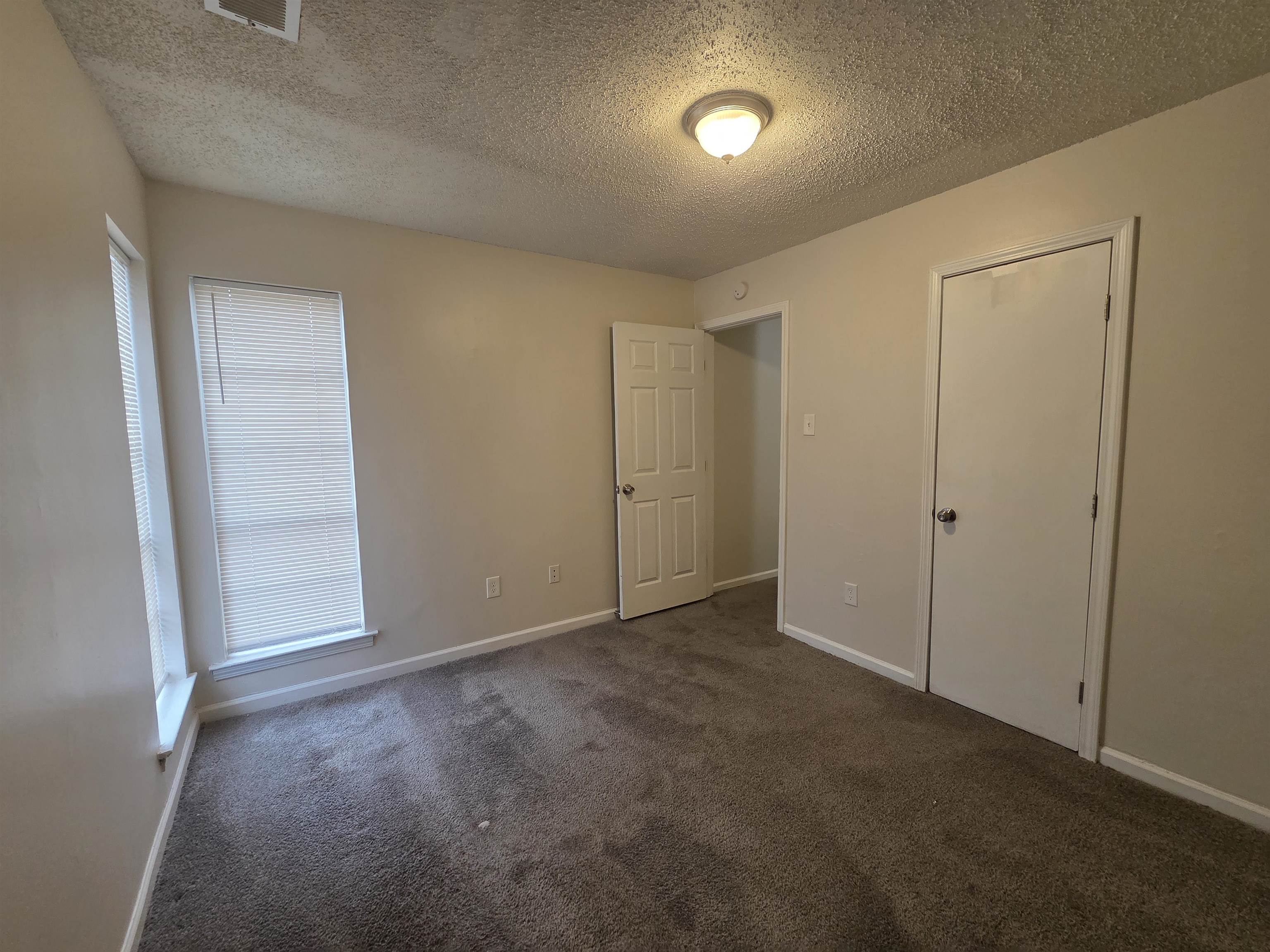 4528 Sugar Creek Road Memphis, TN 38118 - Photo 21 of 40 an empty room with closet and mirror