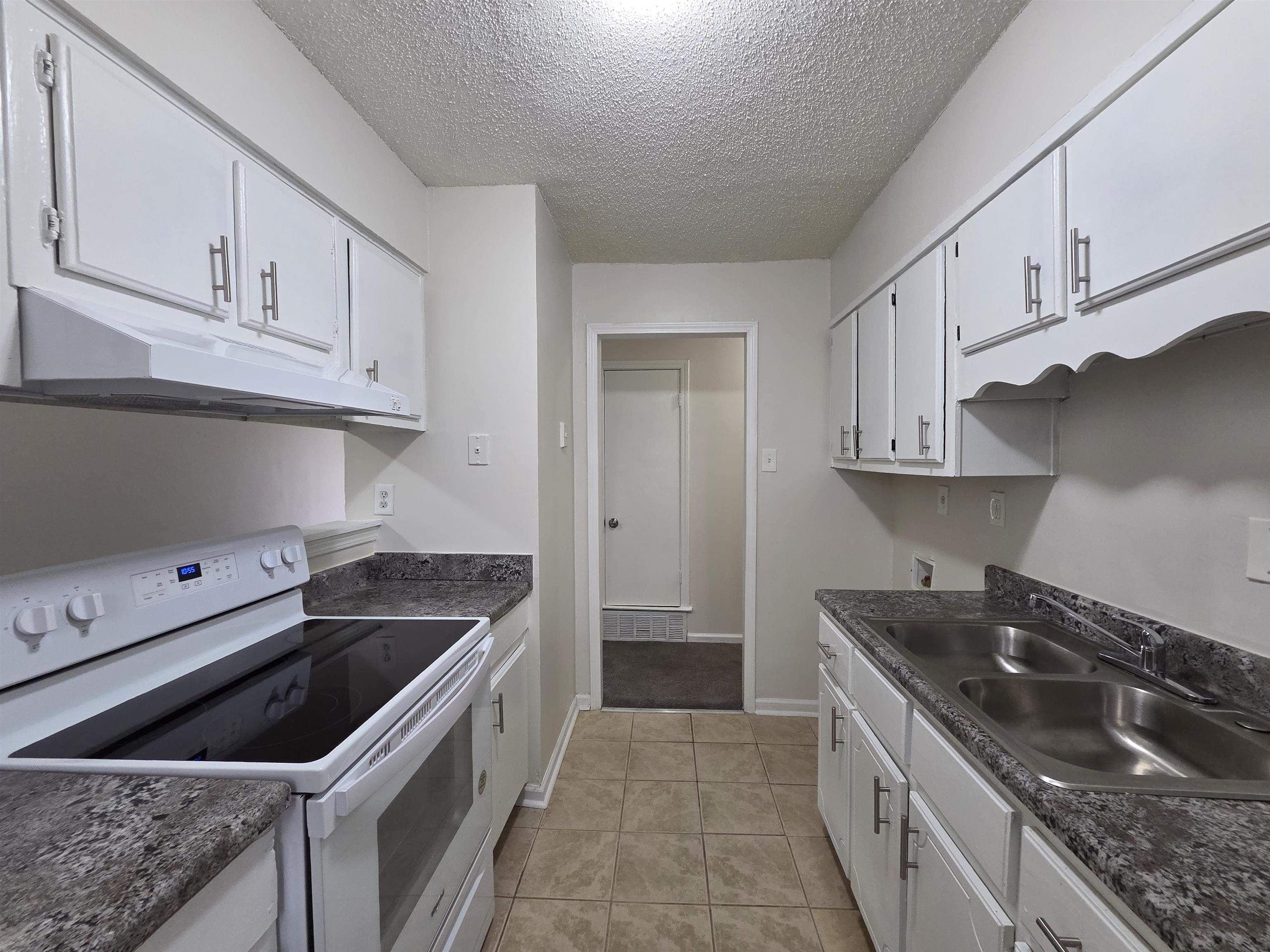 4528 Sugar Creek Road Memphis, TN 38118 - Photo 31 of 40 a kitchen that has a sink and a stove