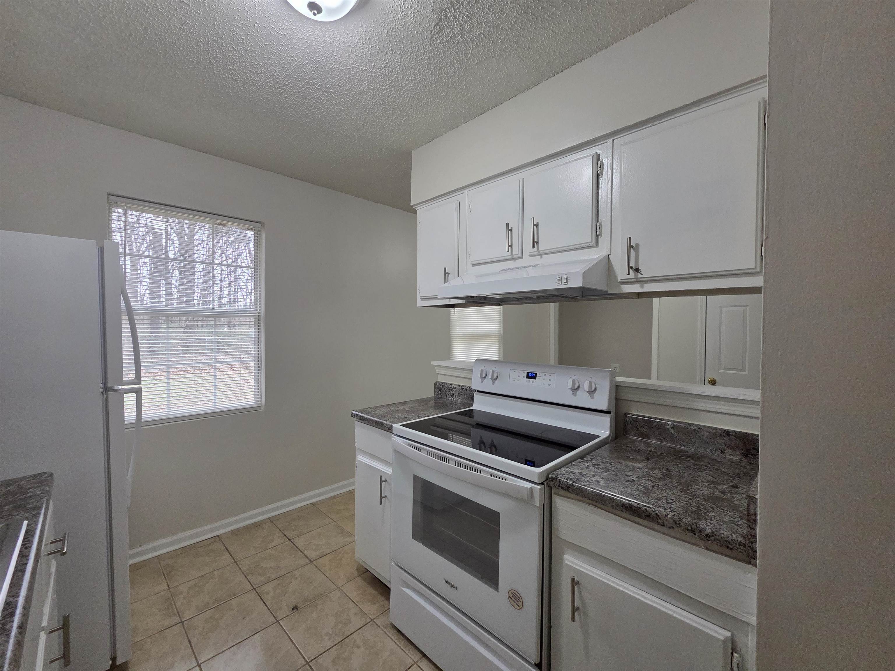 4528 Sugar Creek Road Memphis, TN 38118 - Photo 33 of 40 a kitchen with white cabinets and appliances