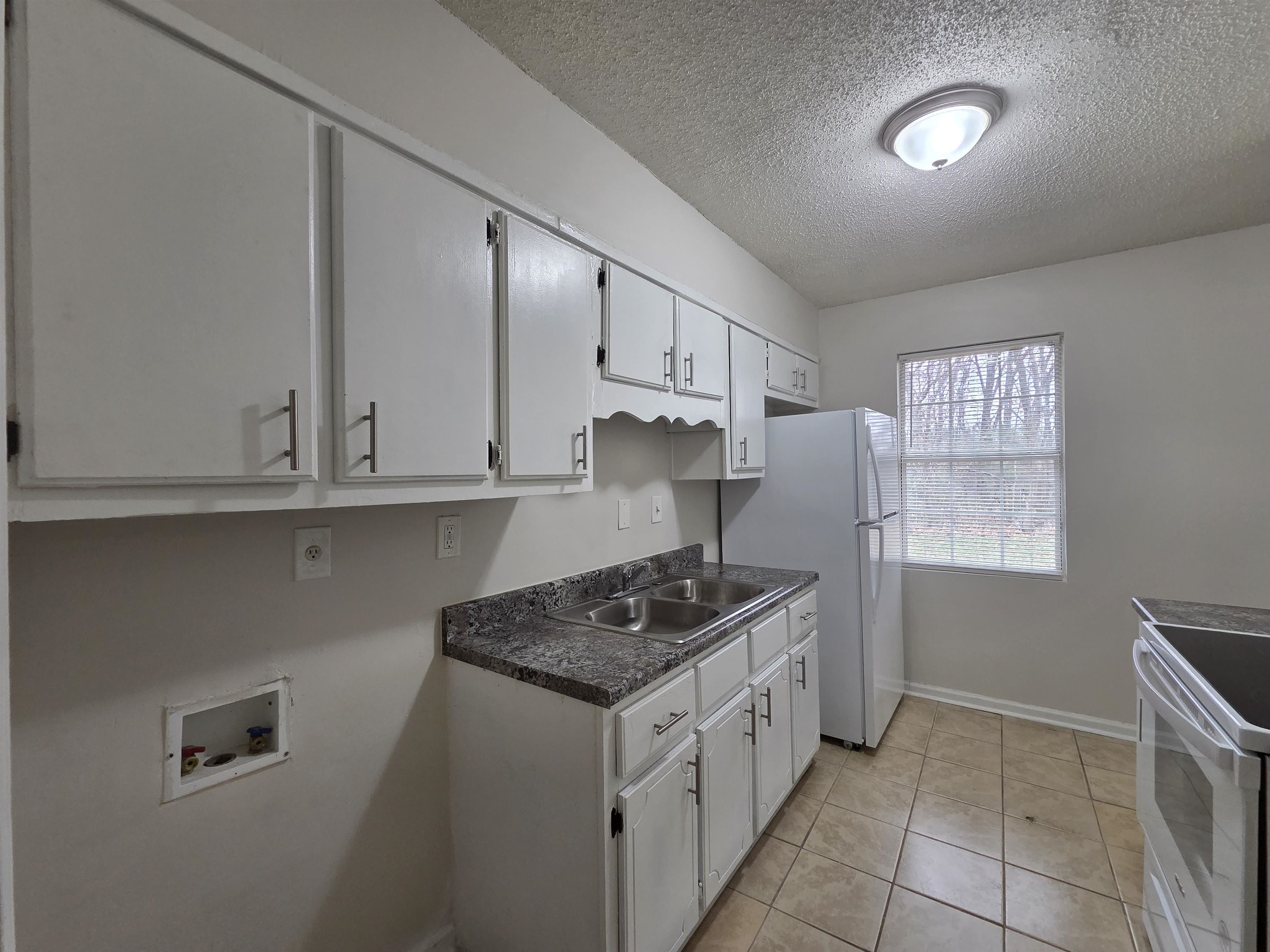 4528 Sugar Creek Road Memphis, TN 38118 - Photo 34 of 40 a kitchen with stainless steel appliances granite countertop a stove a sink and a refrigerator