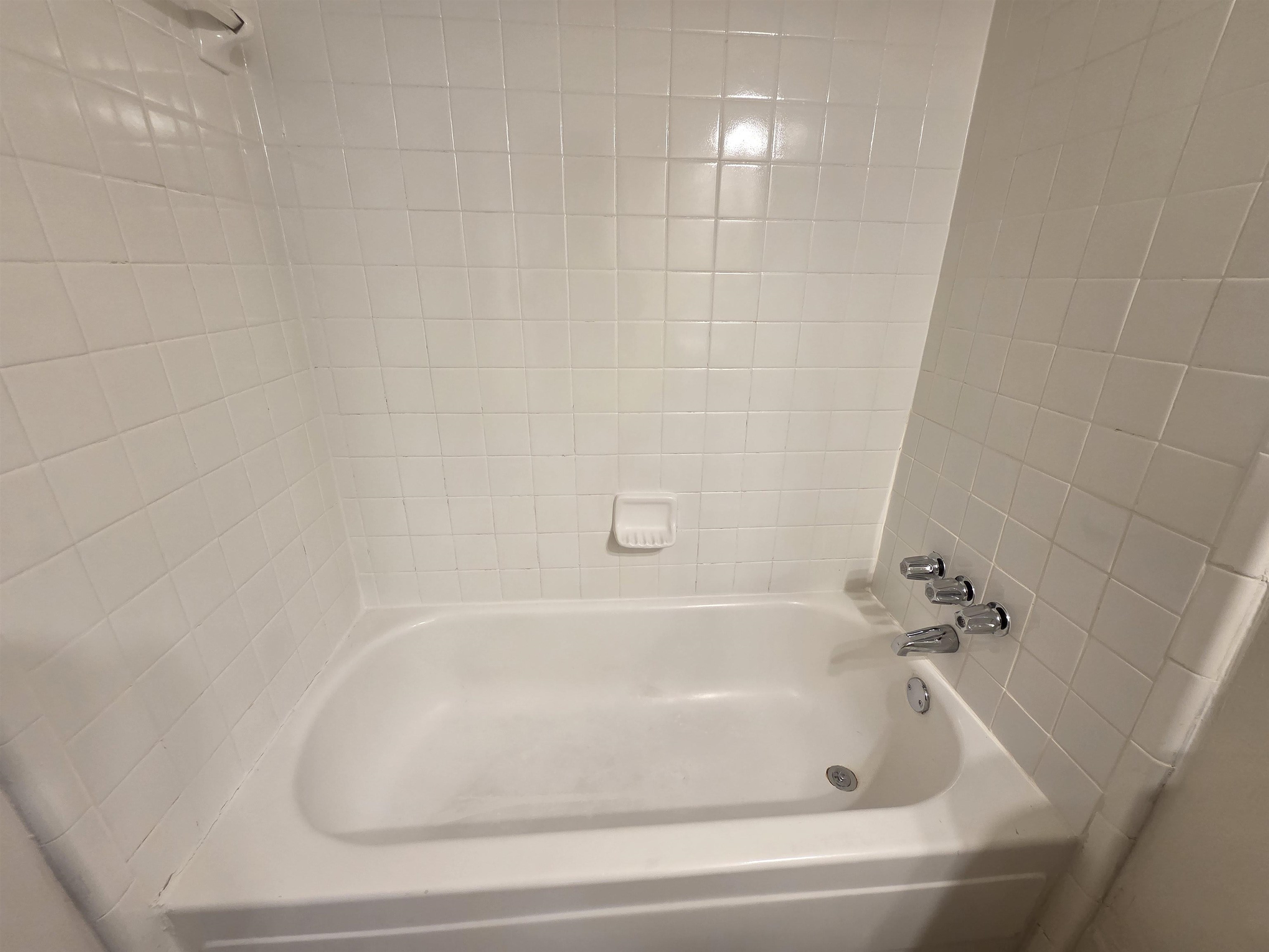 4528 Sugar Creek Road Memphis, TN 38118 - Photo 37 of 40 a white bath tub sitting in a bathroom