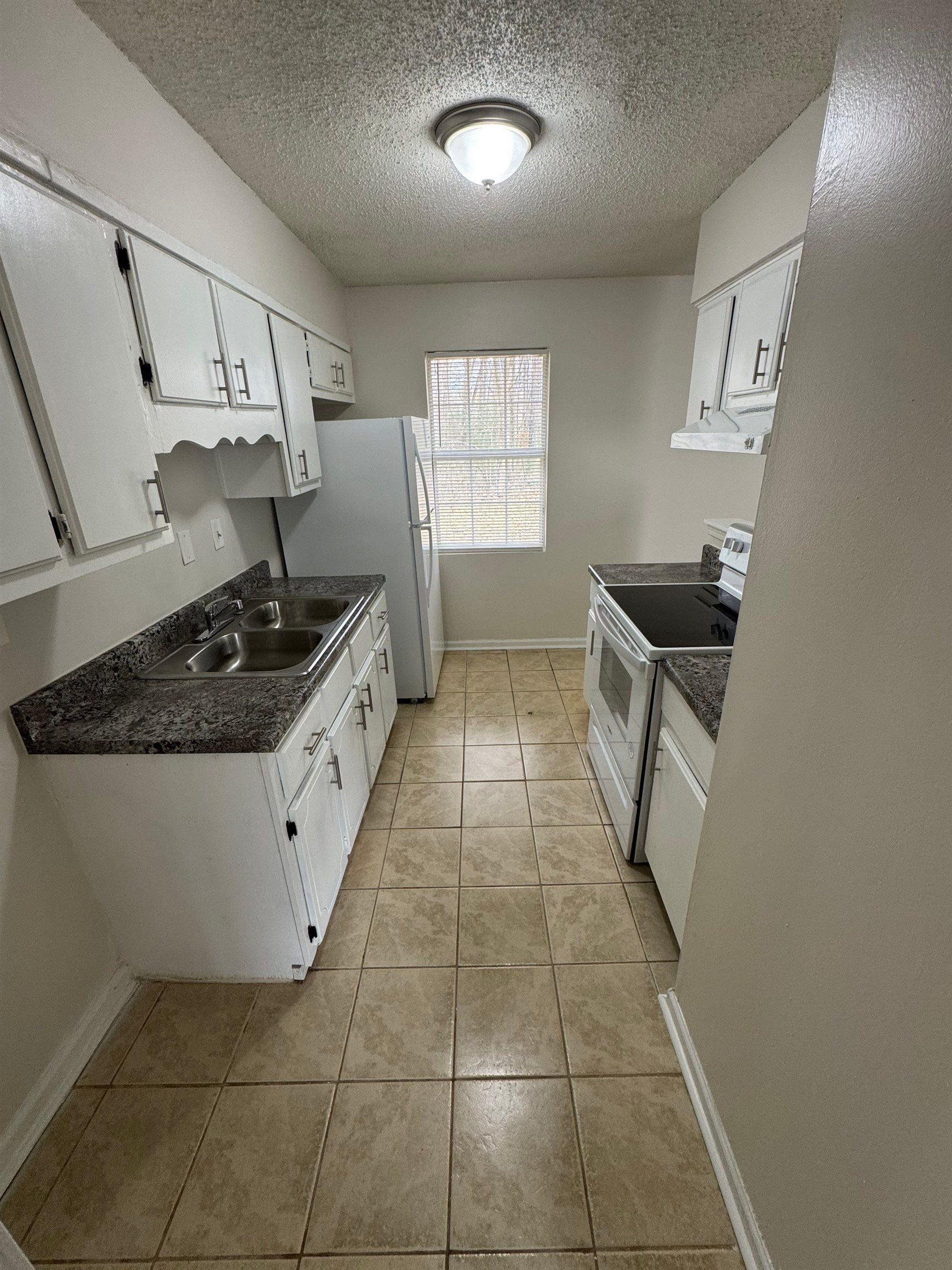 4528 Sugar Creek Road Memphis, TN 38118 - Photo 10 of 19 a kitchen with a sink a stove and cabinets