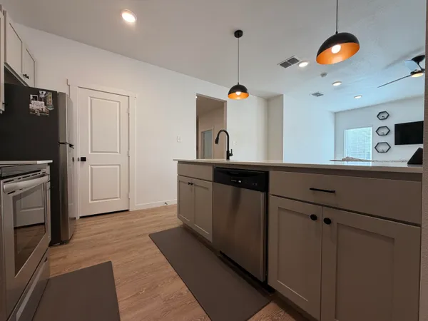 a kitchen with a sink and refrigerator
