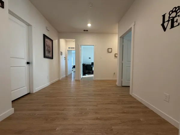 a view of a big room with wooden floor and bathroom
