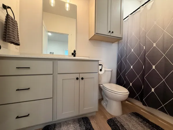 a bathroom with a sink toilet and mirror