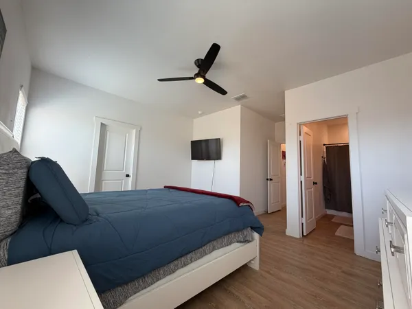 a bedroom with a bed and a television