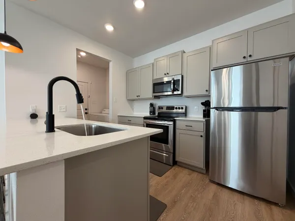 a kitchen with refrigerator a sink and cabinets