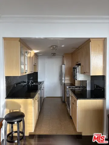 a kitchen with a sink and a stove top oven