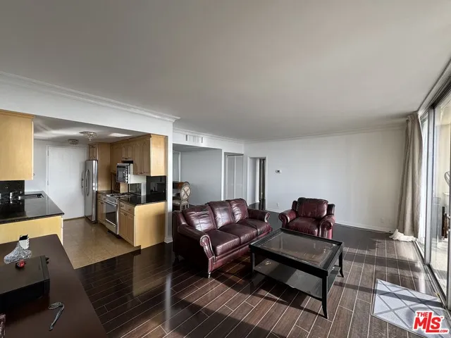 a living room with furniture a rug and a large window