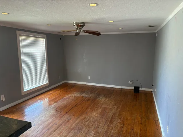 a view of staircase with wooden floor and white walls