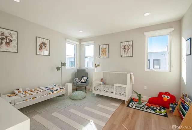 a view of a hallway with wooden floor and entryway