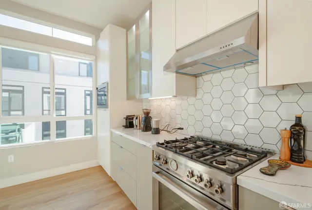a kitchen with cabinets and stove