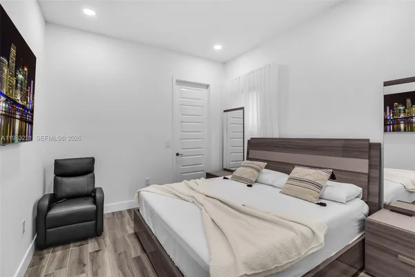 a bedroom with a bed and a chair