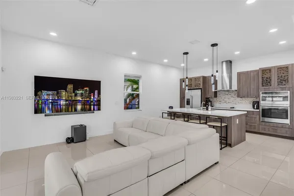 a living room with furniture and a flat screen tv