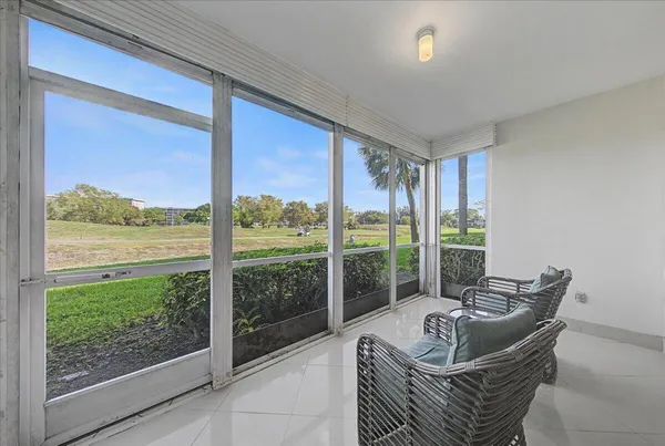 a living room with furniture and a floor to ceiling window