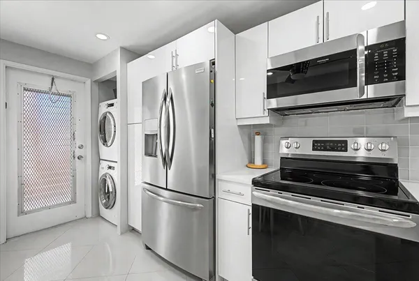 a kitchen with stainless steel appliances a refrigerator stove and microwave