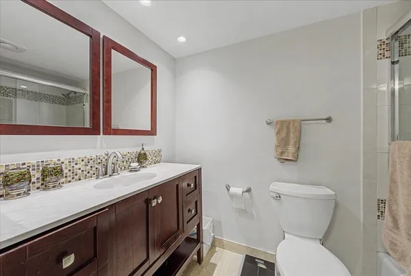 a bathroom with a toilet sink and mirror