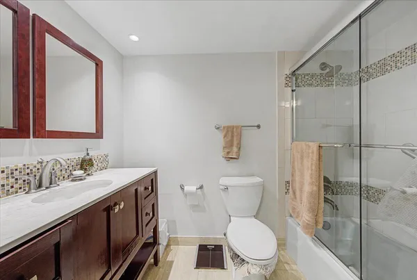 a bathroom with a toilet sink and shower