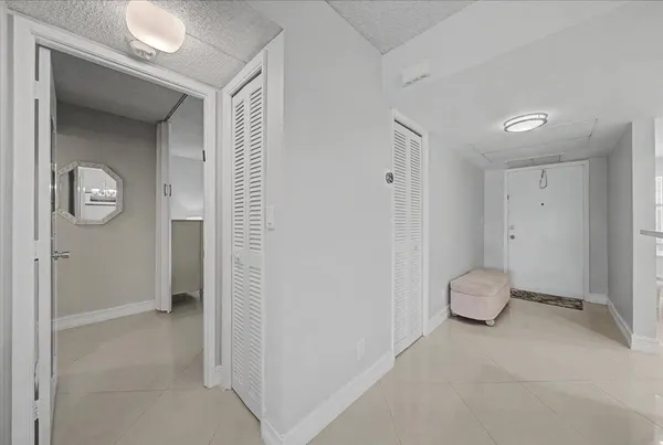 a view of room with hallway and closet