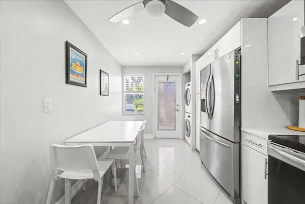 a kitchen with stainless steel appliances granite countertop a refrigerator and a stove top oven
