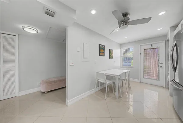 a dining room with furniture and a view of kitchen