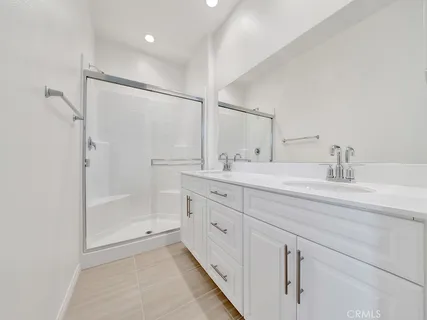 a bathroom with a shower sink and mirror