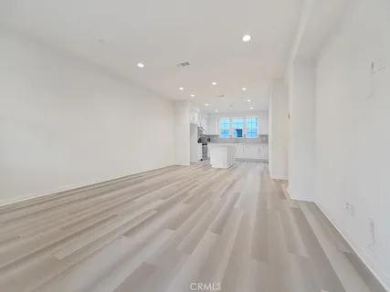 a view of a kitchen with a sink and wooden floor