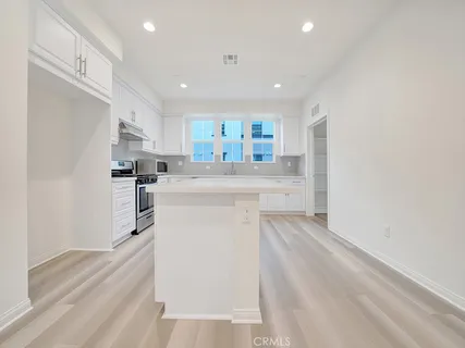 a kitchen with refrigerator and cabinets