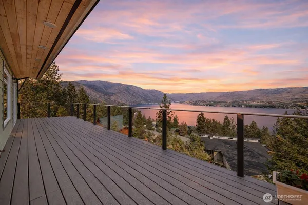 a view of a balcony with wooden floor and city view