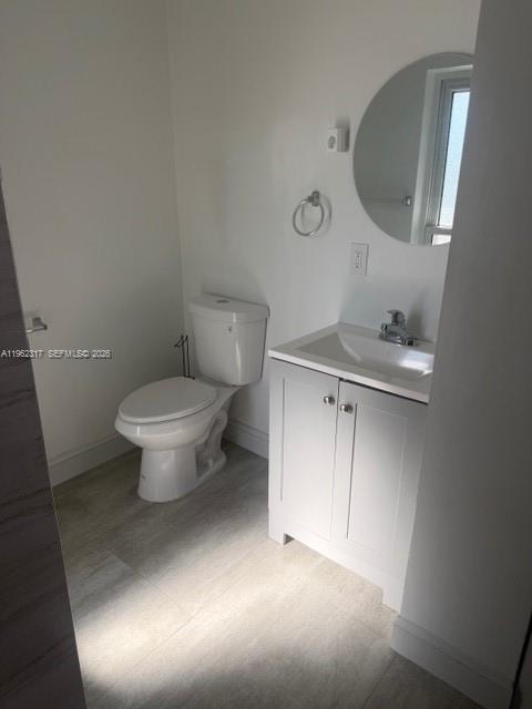 9937 Southwest 194th Street, Unit B Cutler Bay, FL 33157 - Photo 3 of 5 a bathroom with a toilet sink and mirror