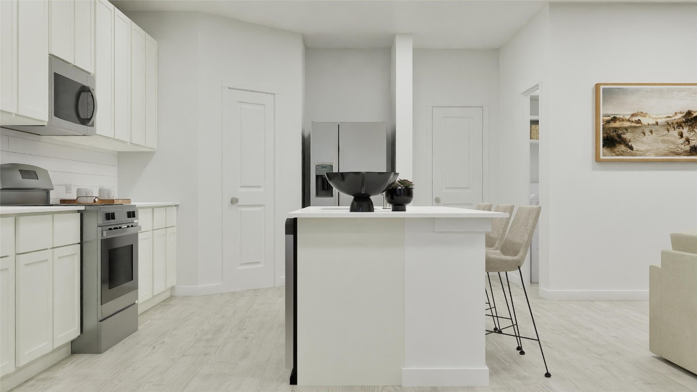 2206 Jeter Drive Bryan, TX 77807 - Photo 11 of 26 a kitchen with a sink a stove and refrigerator