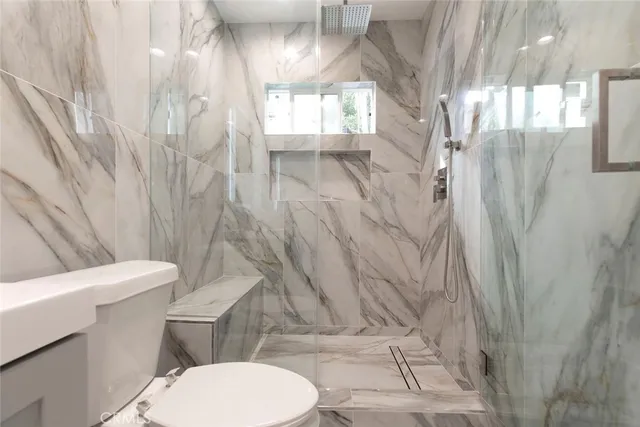 a white toilet sitting next to a shower curtain