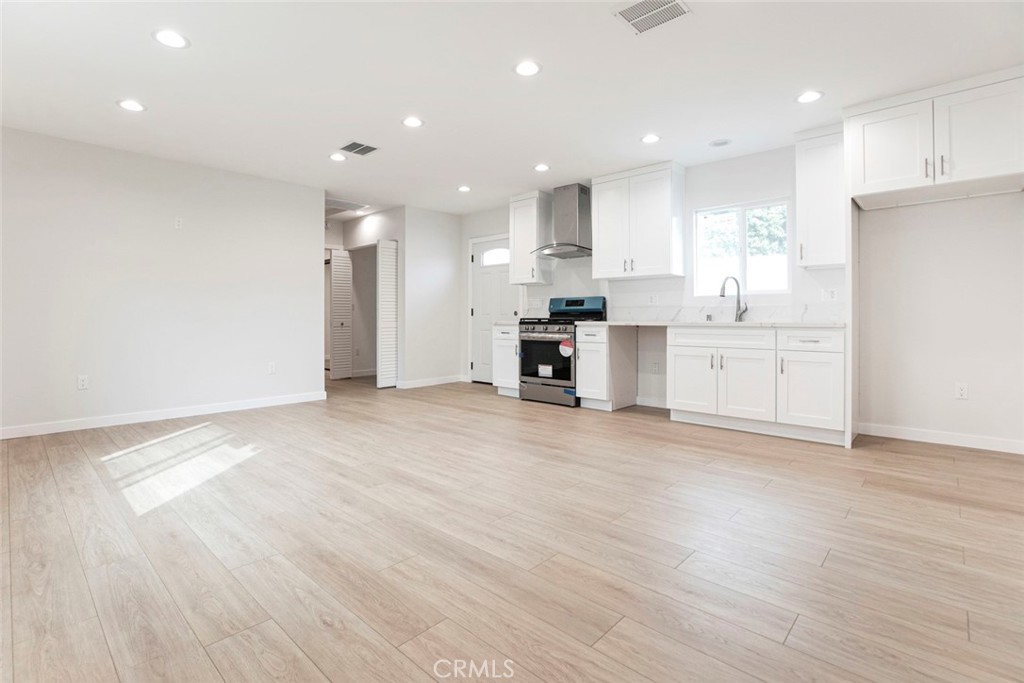 13120 Branford Street Arleta, CA 91331 - Photo 4 of 16 a large kitchen with stainless steel appliances granite countertop a stove a sink and a refrigerator