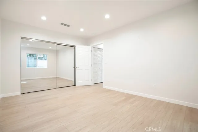 an empty room with a empty space and windows