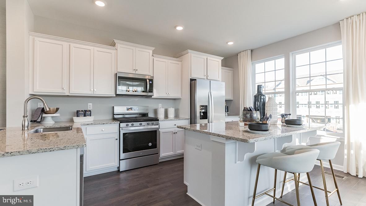 35 Sisters Farmstead Road Mount Laurel, NJ 08054 - Photo 5 of 31 a kitchen with stainless steel appliances granite countertop a stove a sink dishwasher a refrigerator and a microwave oven with wooden floor