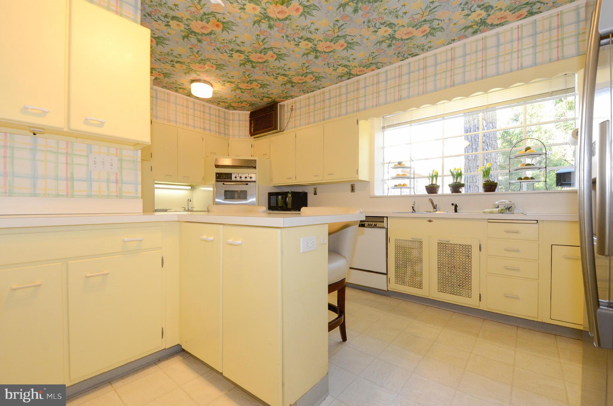 103 Elmwood Road Baltimore, MD 21210 - Photo 14 of 30 a kitchen with sink cabinets and window