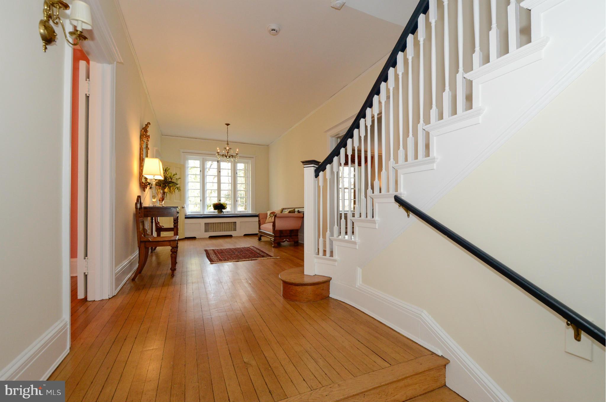 103 Elmwood Road Baltimore, MD 21210 - Photo 3 of 30 a view of a living room and dining room with wooden floor
