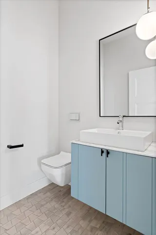 a bathroom with a sink toilet and mirror