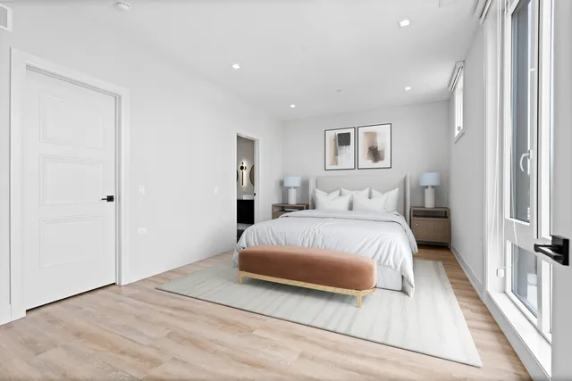 a spacious bedroom with a bed and a walk in closet