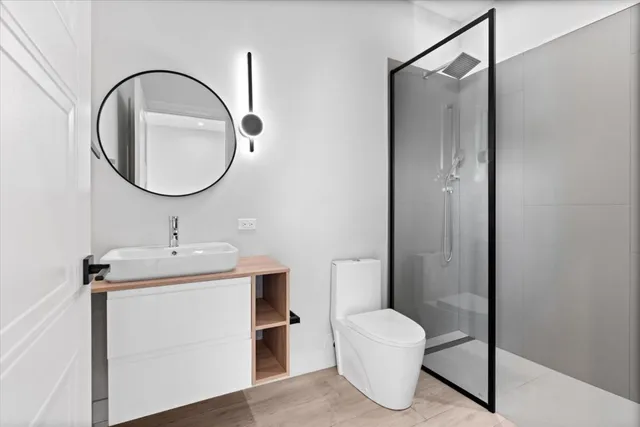 a bathroom with a toilet a sink and a mirror