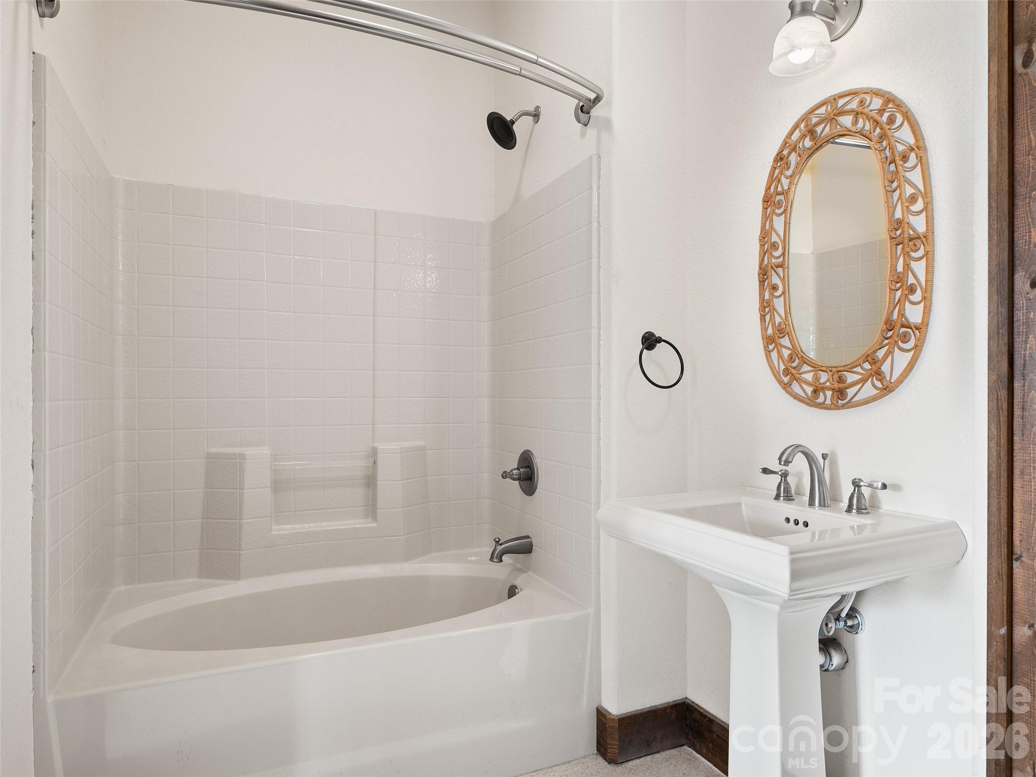 173 Heavenview Point Maggie Valley, NC 28751 - Photo 12 of 47 a bathroom with a sink a mirror and a bathtub
