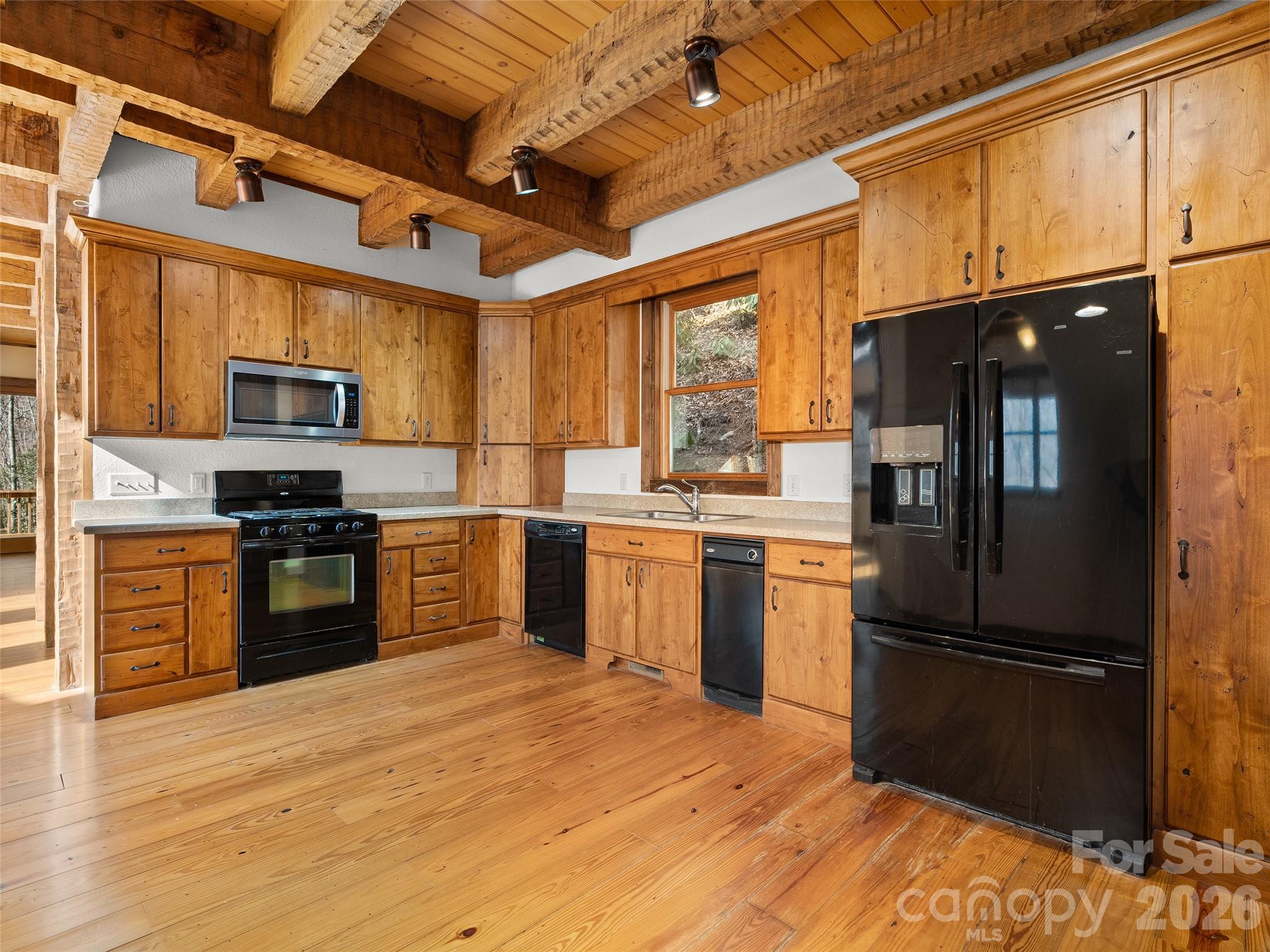 173 Heavenview Point Maggie Valley, NC 28751 - Photo 17 of 47 a kitchen with granite countertop a refrigerator stove and microwave