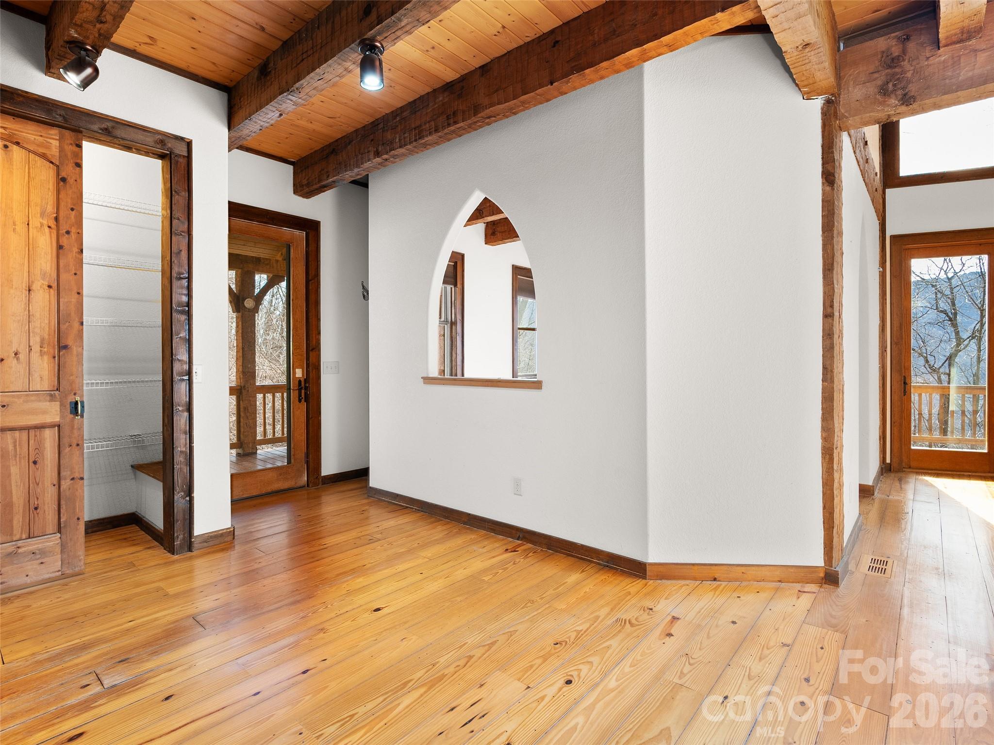 173 Heavenview Point Maggie Valley, NC 28751 - Photo 20 of 47 a view of an empty room with wooden floor and a window