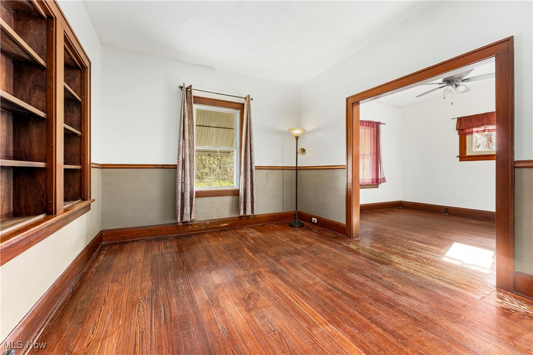 Empty room featuring hardwood / wood-style flooring and ceiling fan