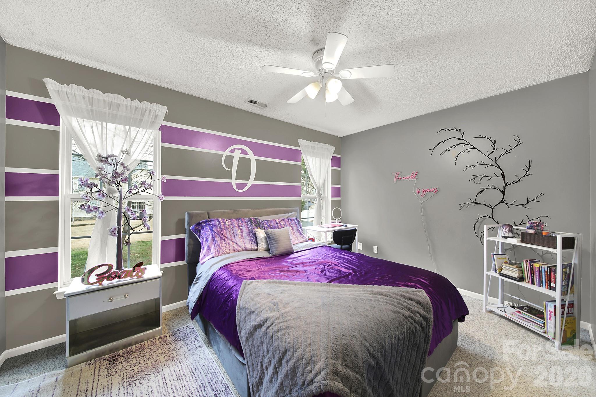 308 Patrick Avenue Southwest Concord, NC 28025 - Photo 11 of 26 a bed sitting in a bedroom next to a window and a chandelier