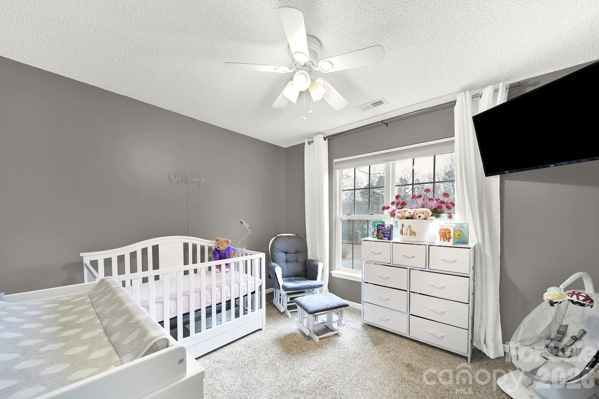 308 Patrick Avenue Southwest Concord, NC 28025 - Photo 12 of 26 a bedroom with furniture and a window