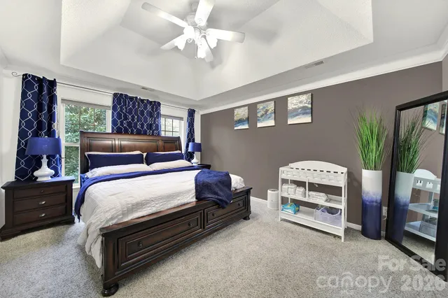 a bedroom with bed and a chandelier