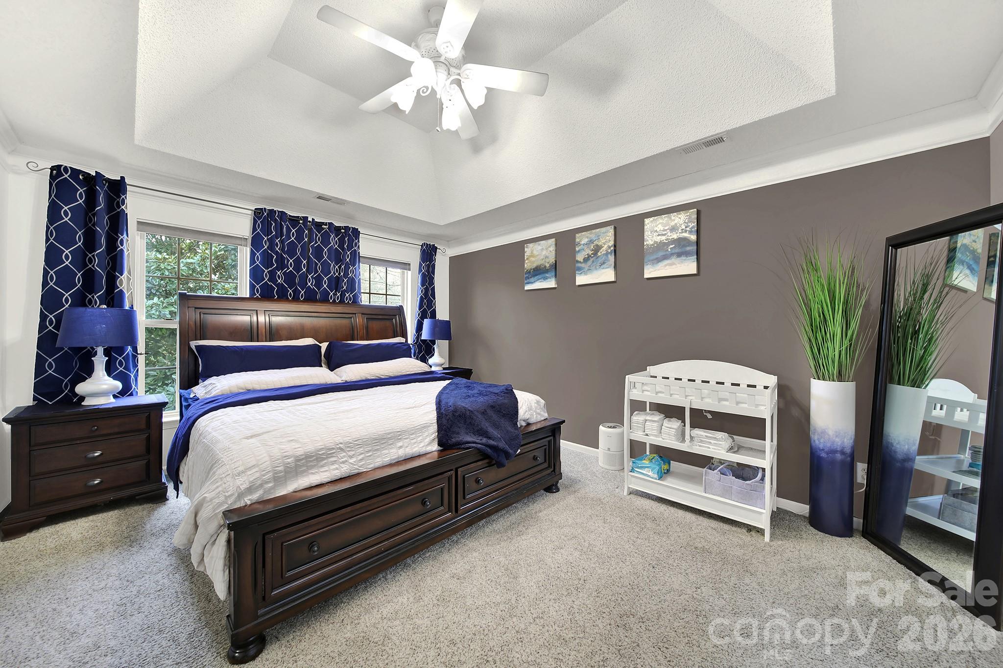 308 Patrick Avenue Southwest Concord, NC 28025 - Photo 14 of 26 a bedroom with bed and a chandelier